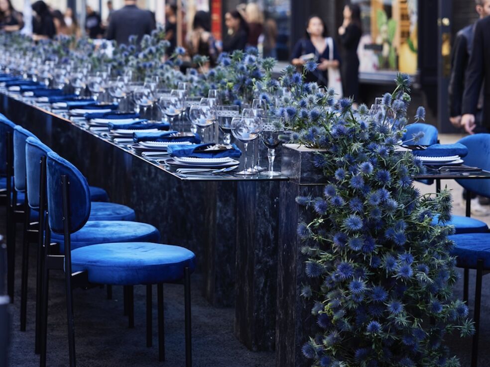 Table detail with blue thistle florals and navy velvet seating